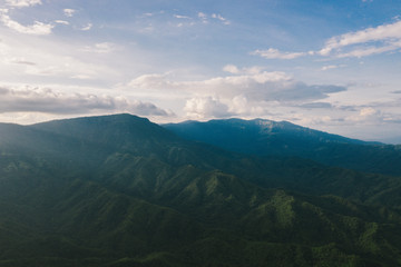 Fototapeta premium Aerial view of mountains and chewed roads on the mountain during sunset at Khao Kho Viewpoint, Phetchabun Province, Thailand