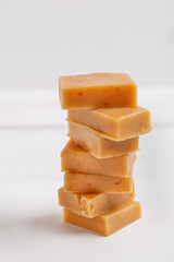 Fresh caramel fudge candies on white rustic background
