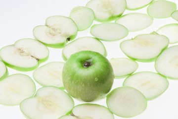 Close up of the green apple with drops and slices