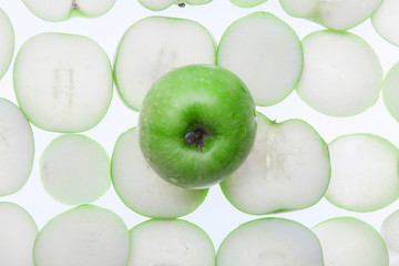 Close up of the green apple with drops and slices. Top view