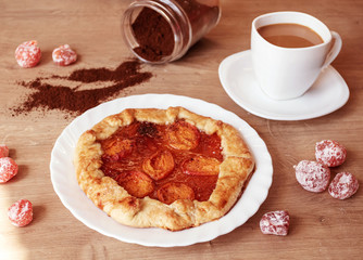 Apricot pie with coffee on kitchen table. Summer berry biscuit recipe.