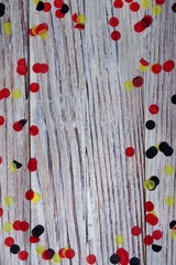 October 3, happy German independence Day. the concept of patriotism , freedom and independence. black, yellow and red confetti on wooden background