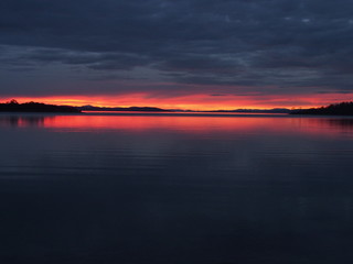 Reflection of sunset and moutains on lake 