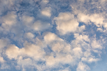 fluffy white clouds on blue sky background