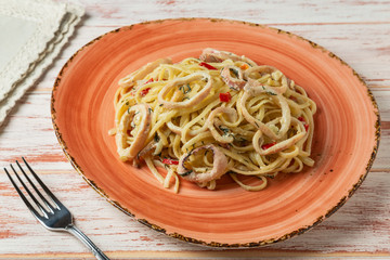 Pasta with squid and herbs in cream sauce. 