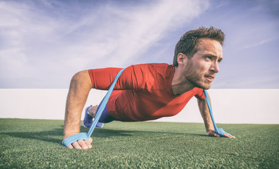 Resistance band pushup fit man fitness exercise with rubber bands difficulty.