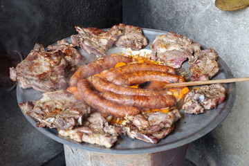High angle view of pork meat on the barbecue plate