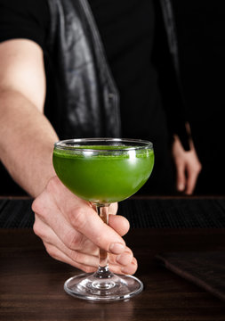 Green cocktail being served