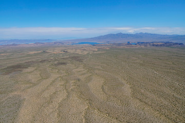  Aerial view of desert next the Lake Mead in Mohave County, Arizona, United States. Arid endless desert during hot summer season