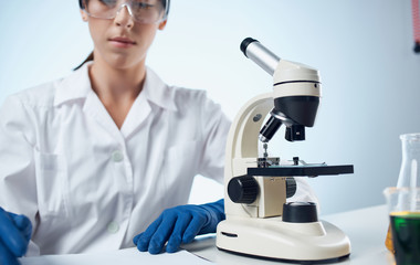 scientist looking through microscope