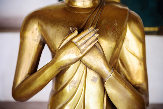 Close up hand of Golden buddha statue in the temple