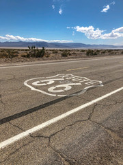 The famous Route 66 emblem painted on Route 66 in the California Desert. 