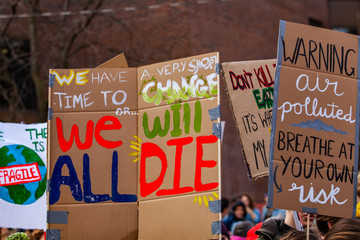 Cardboard signs at ecological protest. A closeup view of a homemade banner at an ecological...
