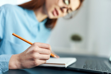 young woman writing in notebook