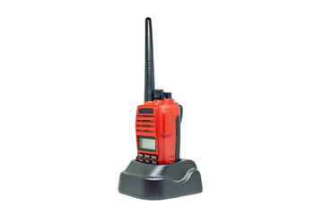 Red communication radio with charging cradle isolate on white background with clipping path. Walkie-Talkies with Battery charger on white background.
