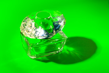 perfume glass bottle on light green background. Eau de toilette
