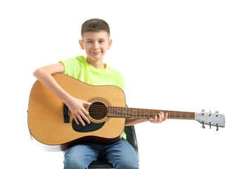 Teenage boy playing guitar against white background