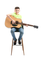 Teenage boy playing guitar against white background