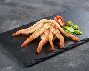 sashimi shrimp with cocumber on the dark plate