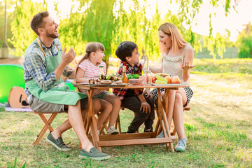 Happy family having picnic on summer day