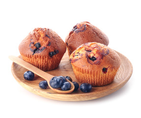 Plate with tasty blueberry muffins on white background
