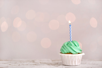 Tasty Birthday cupcake against defocused lights