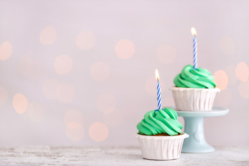 Tasty Birthday cupcakes against defocused lights
