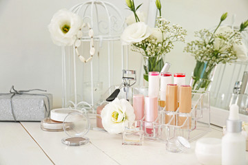 Makeup cosmetics on white dressing table