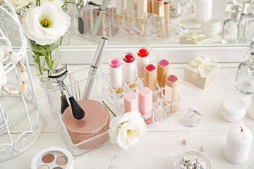 Makeup cosmetics on white dressing table