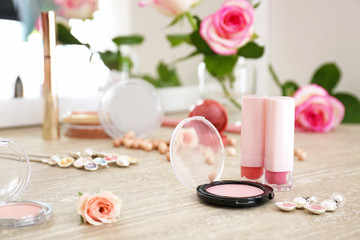 Makeup cosmetics with jewelry on dressing table