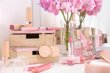 Obraz na płótnie Canvas Makeup cosmetics with jewelry on dressing table