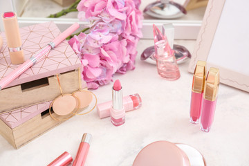 Obraz na płótnie Canvas Makeup cosmetics with jewelry on dressing table