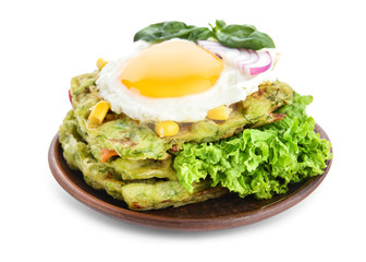 Stack of tasty squash waffles with fried egg on white background