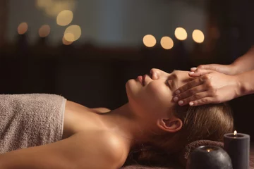 Fototapeten Beautiful young woman receiving facial massage in spa salon © Pixel-Shot