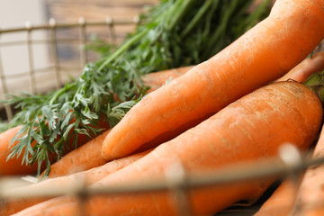 Fresh carrots in basket, closeup