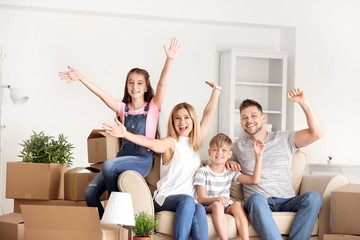 Happy family with belongings in their new house