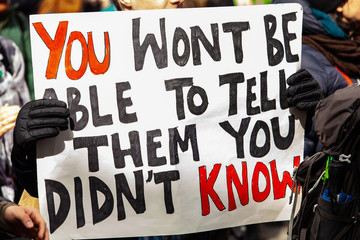 Homemade sign at environmental rally. Environmental protestors are seen close-up holding a sign that say you won't be able to tell them you didn't know, during a street demonstration