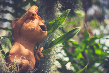 Statue on tree in garden.