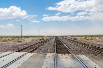 Fototapeta na wymiar Railroad crossing gates on a road in the Mojave Desert in the Southwestern United States. California.