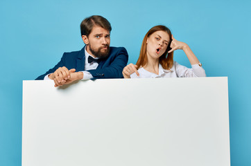 young couple holding white board