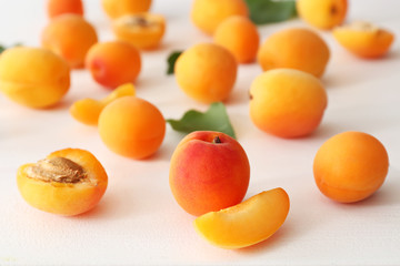 Tasty ripe apricots on white table