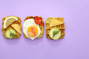 Different squash waffles on color background