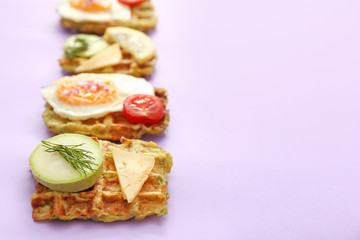 Different squash waffles on color background