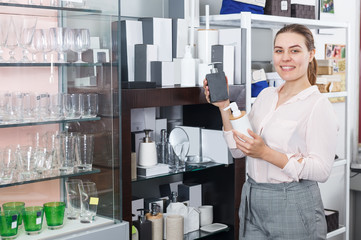  woman choosing bottle for  liquid soap