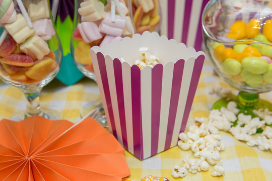 Popcorn in striped bucket . A wide classic box of theater popcorn.