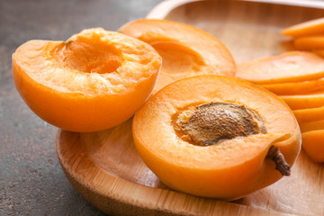 Tasty cut apricots on plate, closeup