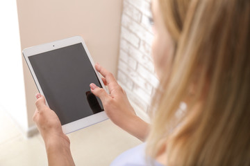 Woman using tablet computer, closeup