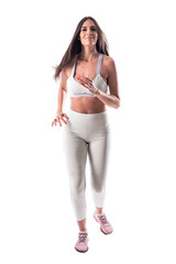 Sporty fit young woman recreational jogger jogging and looking at camera. Full body isolated on white background. 