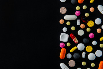 Assorted Pills On A Black Background