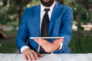 Businessman with mobile phone in his hand.